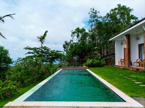 a swimming pool in the backyard of a house at Ancala Uluwatu in Uluwatu