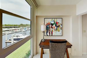 a desk in a room with a window at BeauMer 102B in Naples