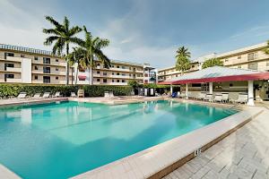 a large swimming pool in front of a building at BeauMer 102B in Naples