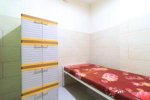 a small room with a bed in a room at Eiffel Residence Tarakan - Female Only in Jakarta +14 photos