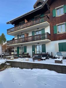a large building with snow in front of it at Belle Vue de St Gervais in Saint-Gervais-les-Bains