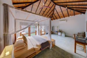 a bedroom with a canopy bed in a room at The Spice Trail in Arugam Bay