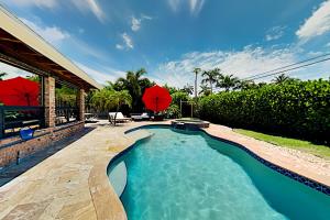a swimming pool in the backyard of a house at Alfresco Beach Getaway in Pompano Beach