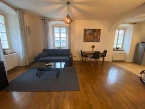 a living room with a couch and a table at Vila Lucia - Apartmán 4 in Pilsen