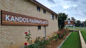 
a brick building with a sign on the side of it at Kandos Fairways Motel in Kandos
