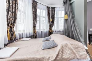 a bedroom with a large bed with curtains at Willa Excelsior in Zakopane