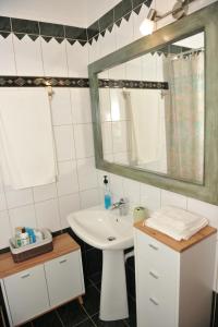 a bathroom with a sink and a mirror at Vila Vasi- Μodern maisonette view Meteora in Kastraki +57 photos