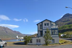 a building with a car parked in front of it at Hotel Aldan - The Post Office in Seyðisfjörður