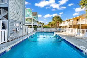 a swimming pool in the courtyard of a apartment building at No Hurry - 302 in Myrtle Beach
