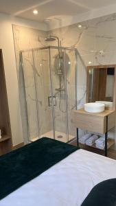 a bathroom with a shower and a sink at Hotel U Catagnu in San-Nicolao