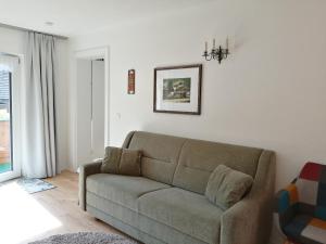 a living room with a couch and a window at Sand 4 in Stanzach