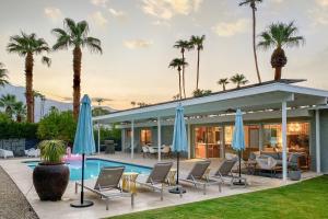 eine Villa mit einem Pool und Palmen in der Unterkunft Serenity in Sunmor Permit# 4761 in Palm Springs