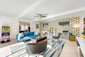 a living room with a blue couch and chairs at Serenity in Sunmor Permit# 4761 in Palm Springs