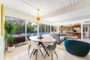 a dining room and living room with a table and chairs at Serenity in Sunmor Permit# 4761 in Palm Springs