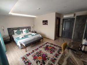 A bed or beds in a room at Florya Novi Hotel