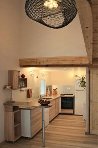 a kitchen with a table and aendant light at chez anna in Montbrand