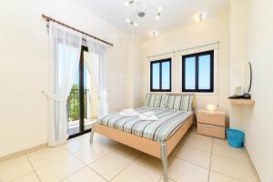 a bedroom with a bed and a large window at Protaras Centro Villa in Protaras