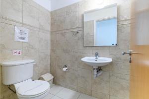 a bathroom with a toilet and a sink at Protaras Centro Villa in Protaras