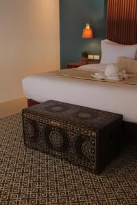 a black box sitting on the floor next to a bed at Mua Tala Hotel El Nido in El Nido