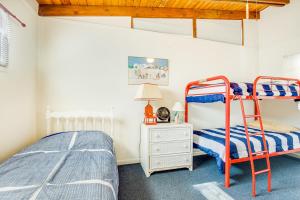 a bedroom with two bunk beds and a lamp at Town of Fenwick island --- 1310 Bunting in Fenwick Island