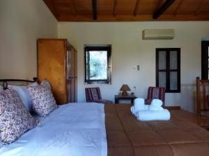 A bed or beds in a room at Agroikia