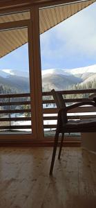 a chair in a room with a large window at Під Горбком in Bukovets