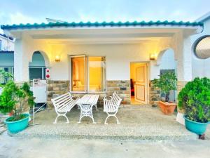 a patio with two chairs and a table at 獨棟山水心旅棧 in Kenting