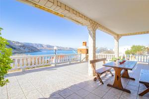 a patio with a table and a view of the water at Diana mountain and seaview in Metajna