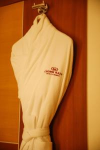 a white shirt is hanging on a door at Crowne Plaza Sohar, an IHG Hotel in Sohar
