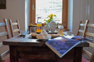 a wooden table with food on top of it at La Maison De José in Aosta