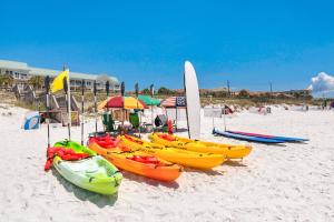 a group of kayaks and umbrellas on a beach at Maravilla in Destin