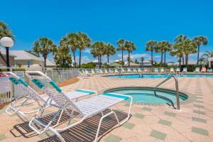 a pool with two lounge chairs next to a swimming pool at Maravilla in Destin