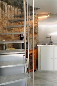 a kitchen with metal stairs in a room with a sink at Moinho.com in Rio Maior
