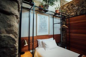 a bedroom with a four poster bed with white sheets at Bastion House in Irene