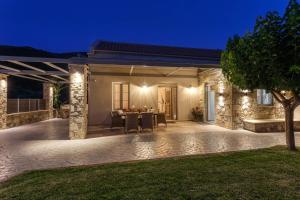a patio of a home at night at Villa 4 DESTINA in Élos