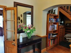 a vase of flowers on a counter in a room at Karoo Life B&B in Calitzdorp