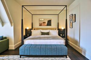 a bedroom with a large bed with a large mirror at The Grand Hotel Birmingham in Birmingham