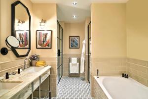 a bathroom with two sinks and a tub and a shower at The Grand Hotel Birmingham in Birmingham