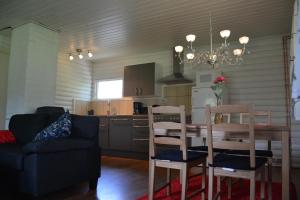 a kitchen and dining room with a table and chairs at Svinö Seaside Villa in Lumparland