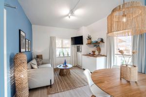 a living room with a table and a couch at South Beach House in Zandvoort +22 photos