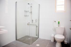 a shower stall in a bathroom with a toilet at Hostel BU93 in Tel Aviv