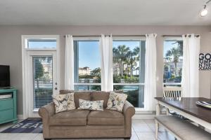 a living room with a couch and large windows at Destiny Beach Villa 11B in Destin