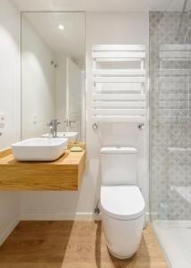a bathroom with a white toilet and a sink at Casa Oso in Panticosa +9 photos