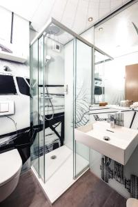 a bathroom with a shower and a sink at Concorde Hotel am Flugplatz in Donaueschingen