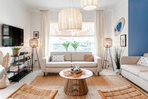 a living room with a couch and a table at South Beach House in Zandvoort