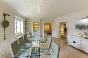 a dining room with a glass table and chairs at President Mezonet Apartment in Brno