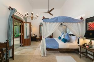 a bedroom with a bed with a canopy at Sundara by Mosvold in Balapitiya