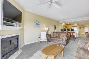 a living room with a couch and a fireplace at Mariners Watch 205 in Ocean City