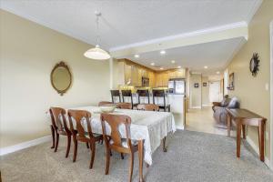 a kitchen and dining room with a table and chairs at Mariners Watch 205 in Ocean City