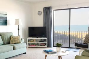 a living room with a couch and a television at Ocean Hideaway in Ocean City